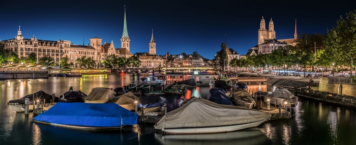 Zurich panorama at night with boats and buildings