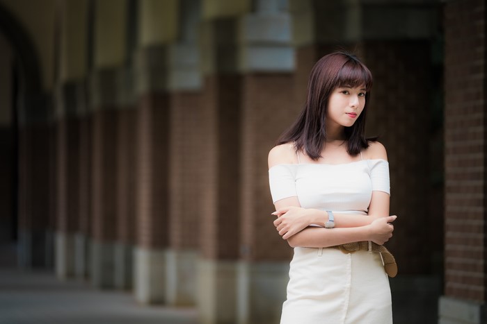 Asian woman in white off-shoulder top and skirt