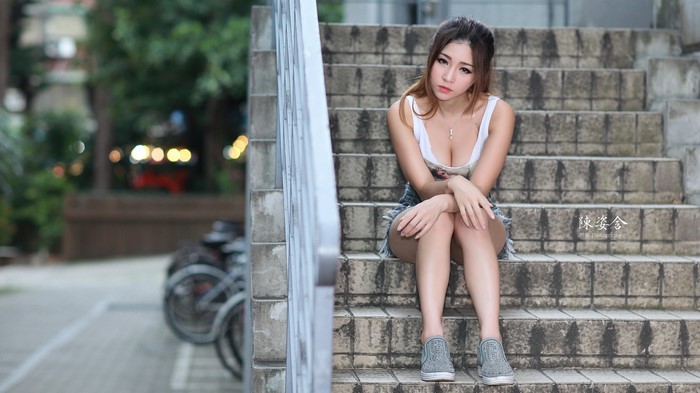Asian Woman Sitting on Stone Stairs