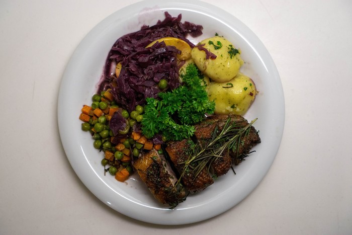 Roast duck with red cabbage, potatoes, and vegetables