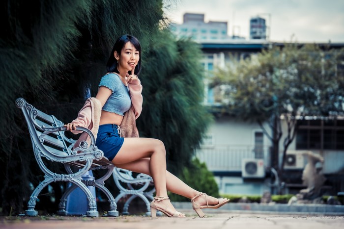 4K Asian Woman Sitting on Bench with Gesture