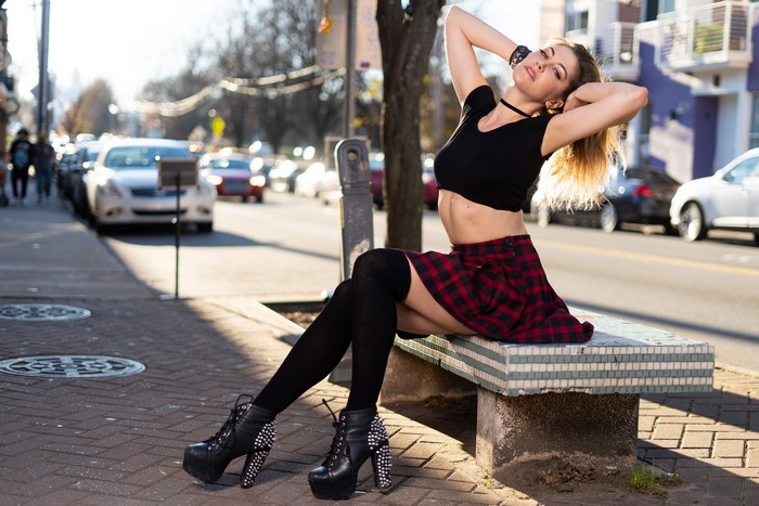 4K Korbi Kay sitting on a bench in the street