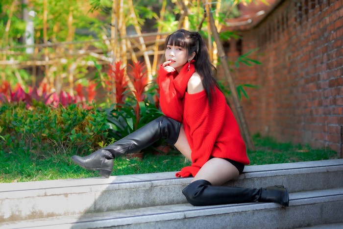 4K Asian Woman Sitting Wearing Sweater and Boots