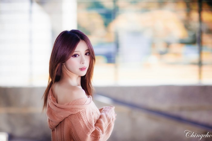 Asian woman with brown hair wearing a sweater