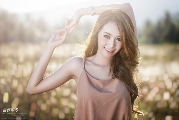 Asian Woman Smiling with Hands Raised