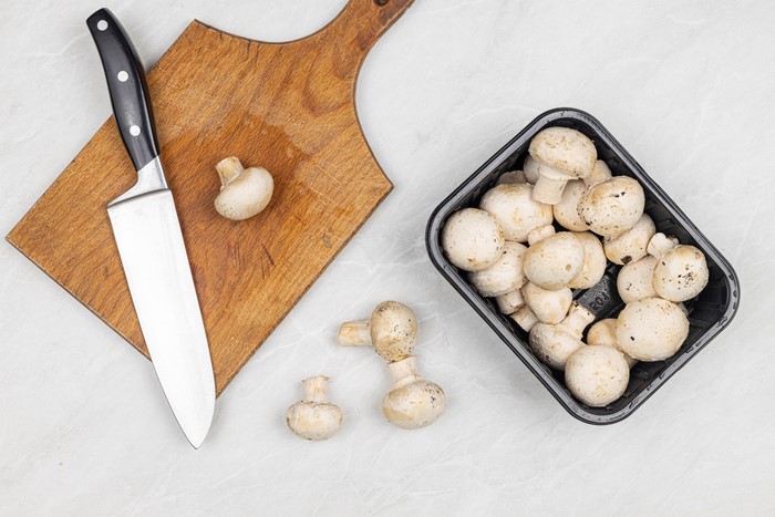Mushrooms and Knife on Cutting Board