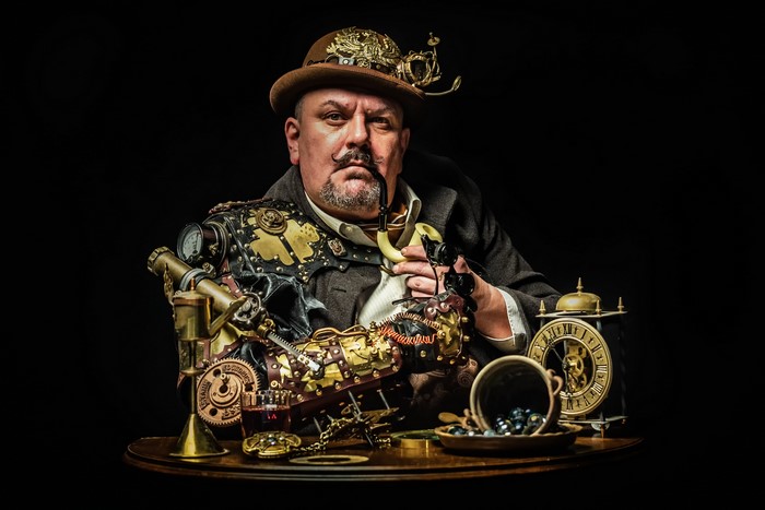 Man in Steampunk attire with pipe and gadgets