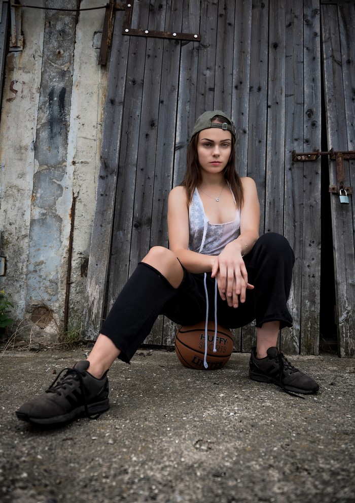 Klaudia Latto sitting on a basketball