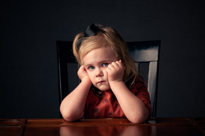Little girl with hands on face