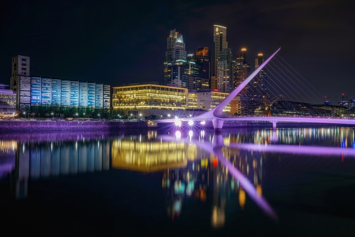 Puente de la Mujer bridge and skyline at night in Buenos Aires