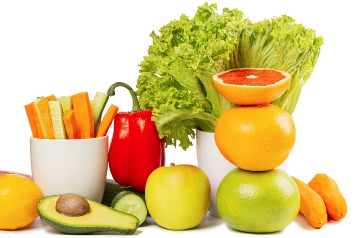 Assortment of fresh fruits and vegetables on a white background