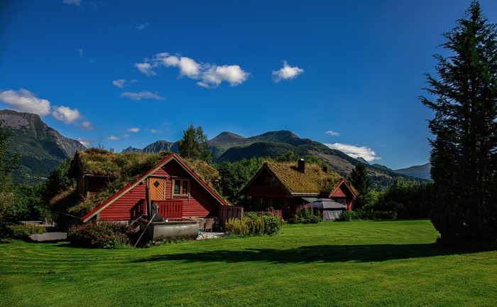 Red houses with grass roofs in Norway mountains