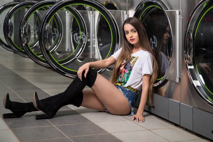 Alexis Contreras Sitting in Laundry Room
