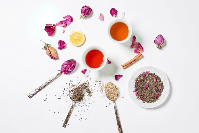 Two cups of tea with rose petals and lemon