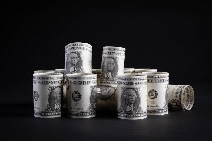 Rolled US Dollar Bills on Black Background