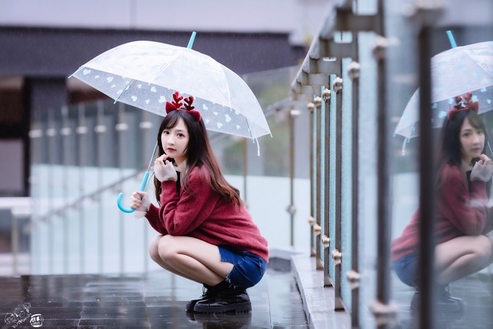 Asian girl with umbrella in the rain