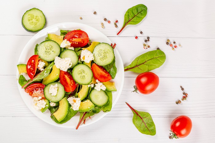 Salad with Tomatoes, Cucumbers, Avocado, and Cheese on a Plate
