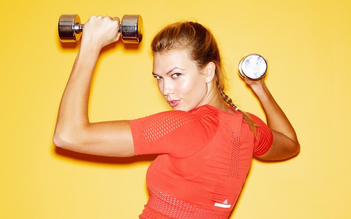 Karlie Kloss exercising with dumbbells