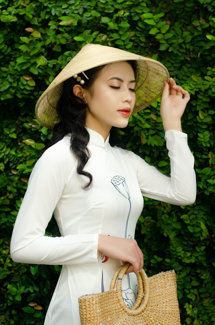 Woman in traditional Vietnamese dress with conical hat