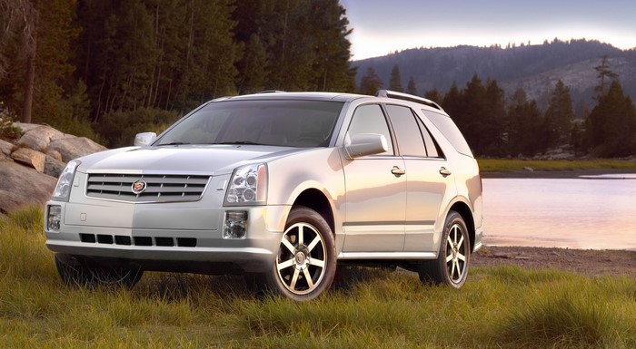 Silver Cadillac SRX Crossover on Grass by Lake