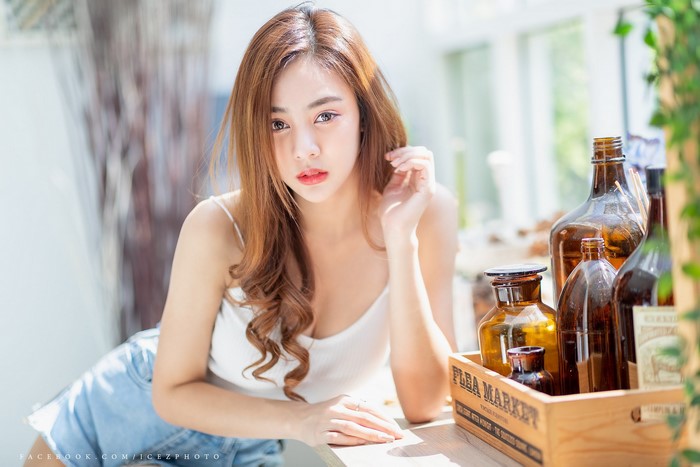 Asian Woman with Brown Hair and Bottles