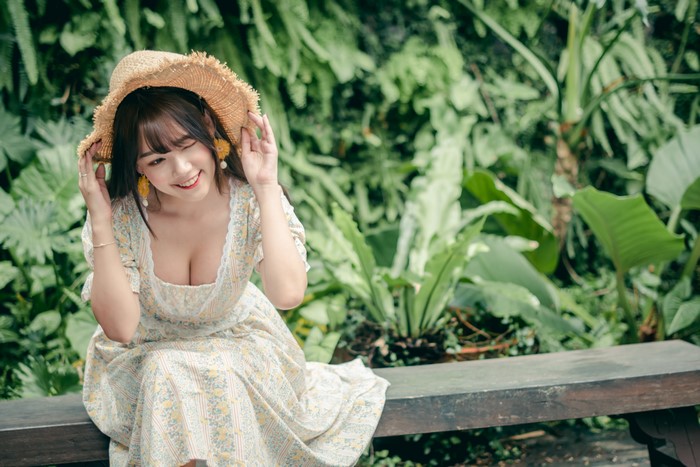 Asian woman wearing a straw hat and dress
