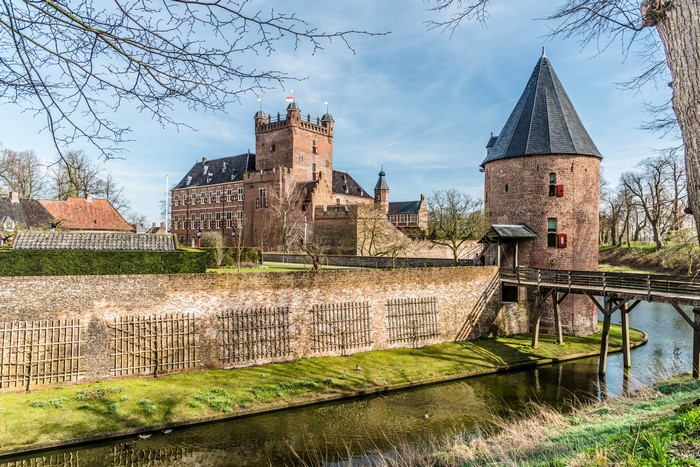Huis Bergh castle with tower and canal in Netherlands