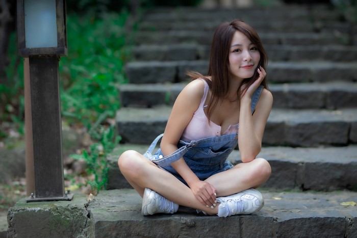 Asian woman sitting on stairs