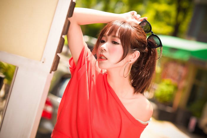 Asian woman with brown hair and sunglasses