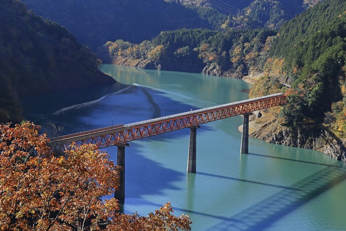 Orange bridge over a turquoise river in Shizuoka Prefecture, Japan