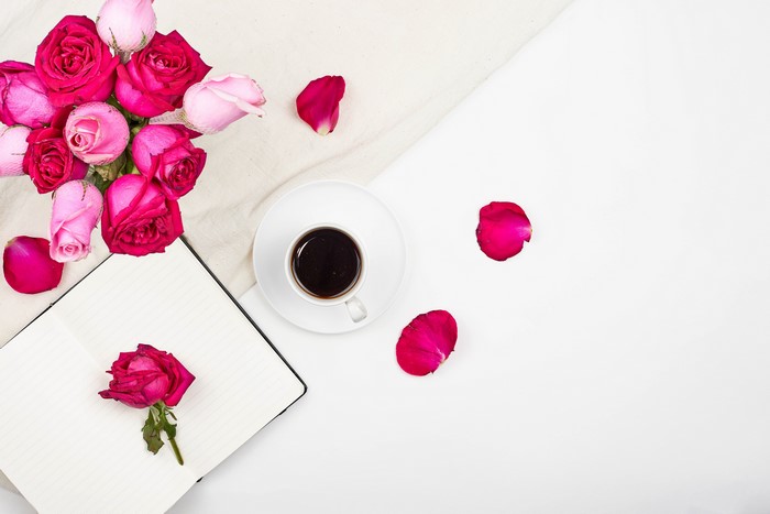 Roses, Coffee, and Notebook on White Background