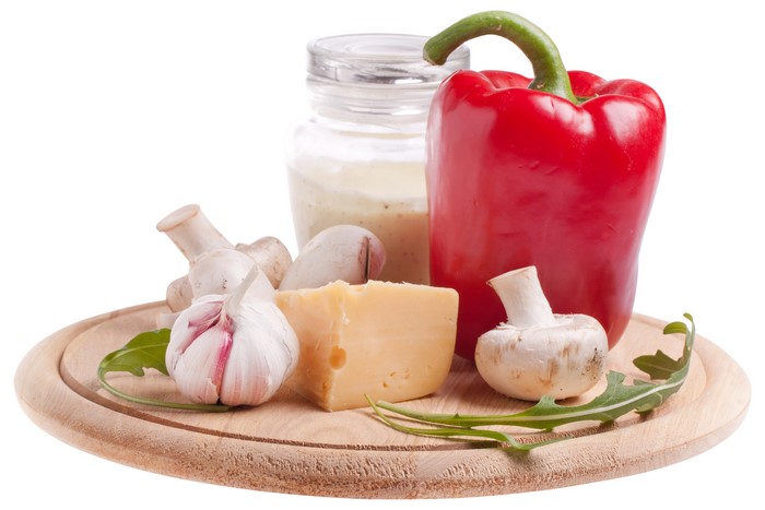 Bell pepper, garlic, cheese, mushrooms, and jar on white background
