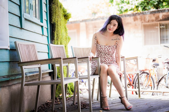 Asian woman sitting on a chair outdoors
