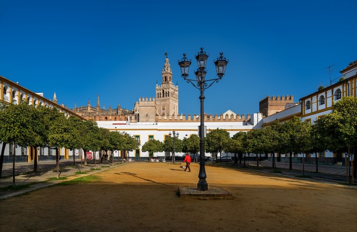 Plaza in Barrio de Santa Cruz, Sevilla, Spain with Giralda tower