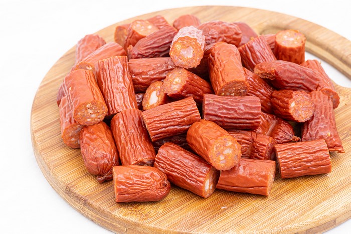 Pile of Vienna sausages on a cutting board