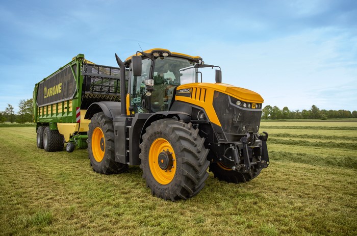 JCB Fastrac 8330 tractor with Krone trailer in field