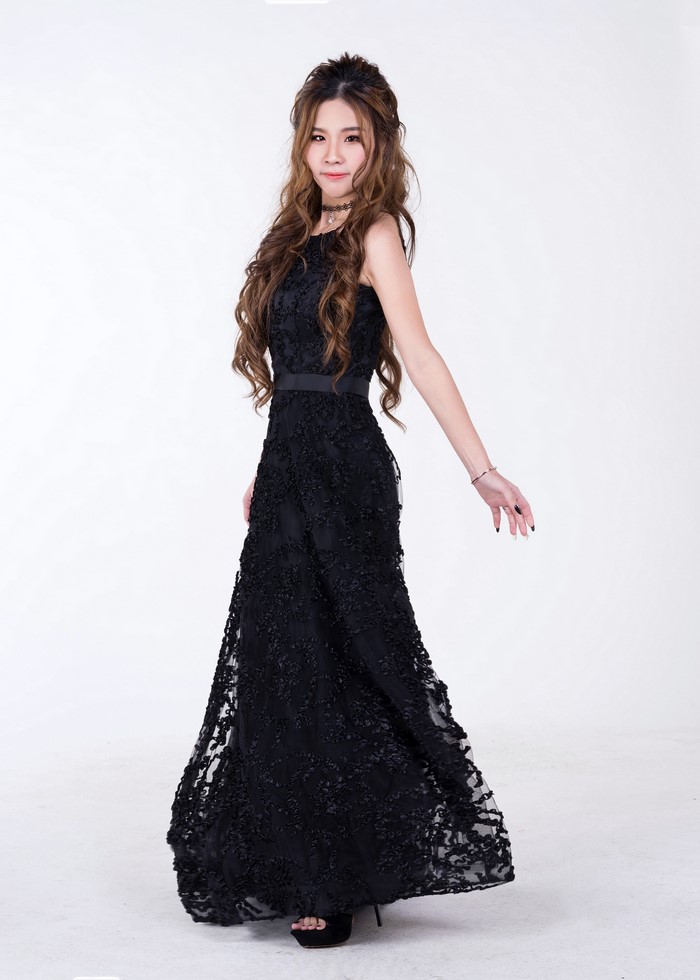Asian woman in a black lace dress posing