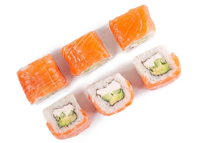 Sushi with salmon and avocado on white background