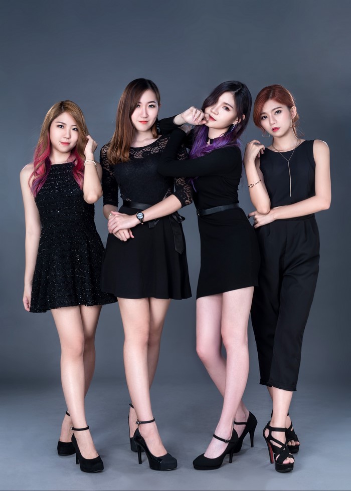 Four Asian Women Posing Elegantly in Black