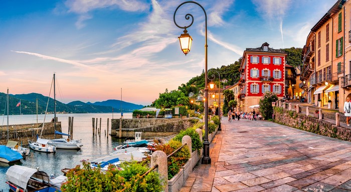 Cannobio waterfront with boats and buildings at sunset