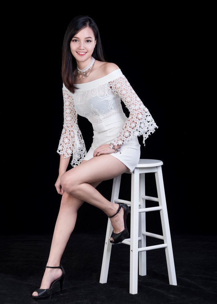 Asian Woman Posing in Elegant White Dress