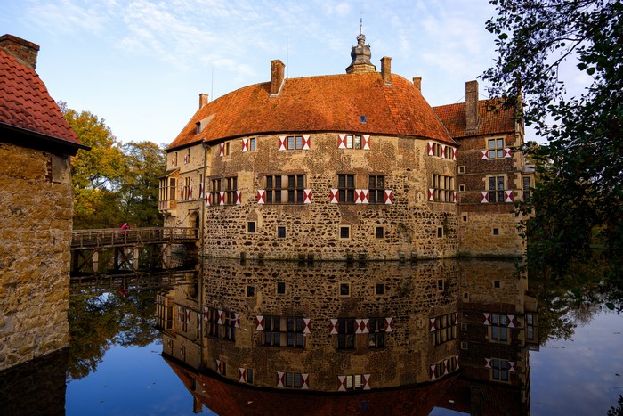 Vischering Castle reflected in the pond with a bridge
