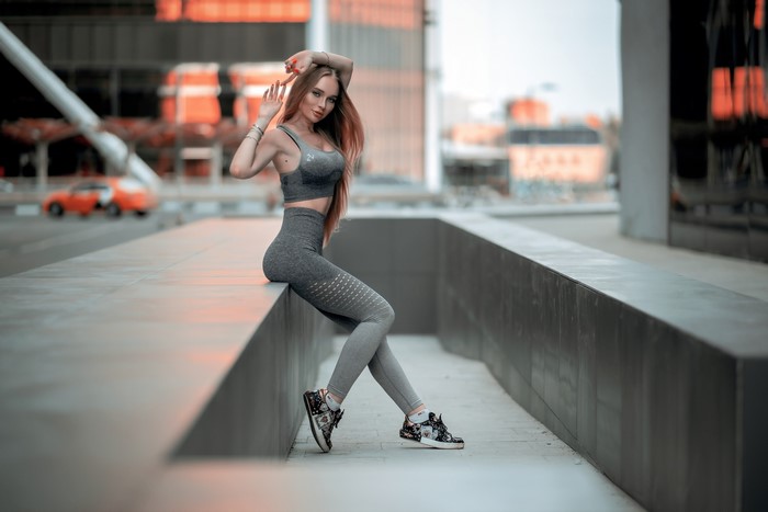 Woman in athletic wear posing outdoors