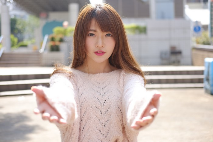 Woman in Sweater Offering Hands