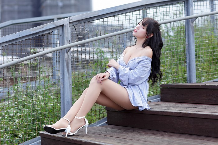 Asian woman sitting on steps