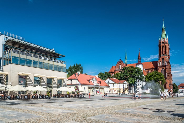 Town square with church and cafe in Poland