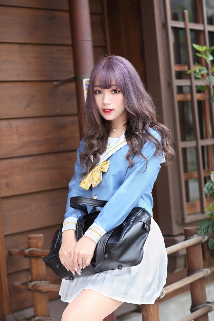 Asian Schoolgirl in Blue Uniform with Handbag