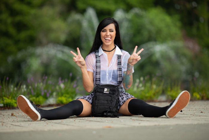 Brunette Girl Sitting with Handbag and Peace Gesture 4K