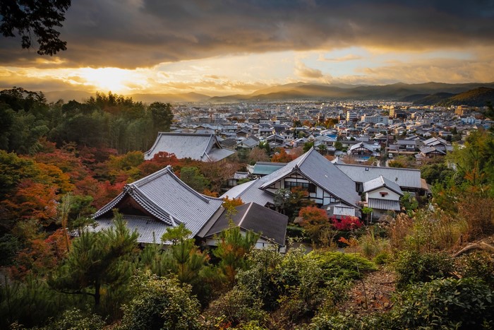 Kyoto cityscape with traditional Japanese roofs and autumn foliage
