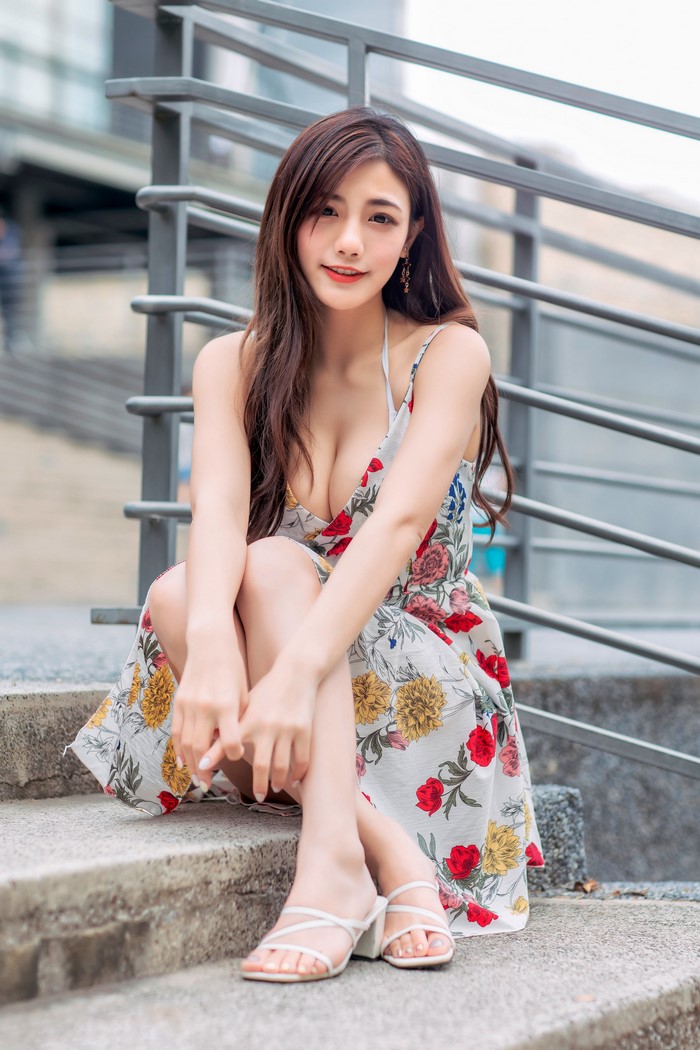 Asian Woman Sitting in Floral Dress